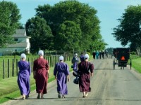 A group of young Amish women walking along the road